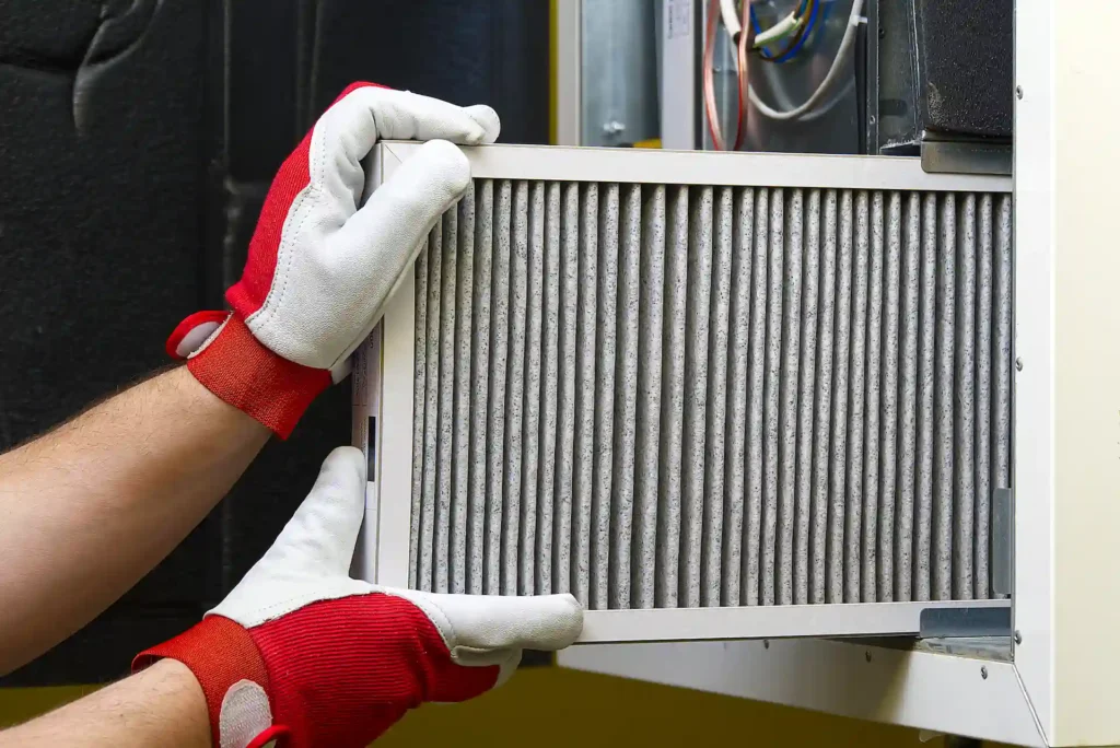 technician checking air filters in home